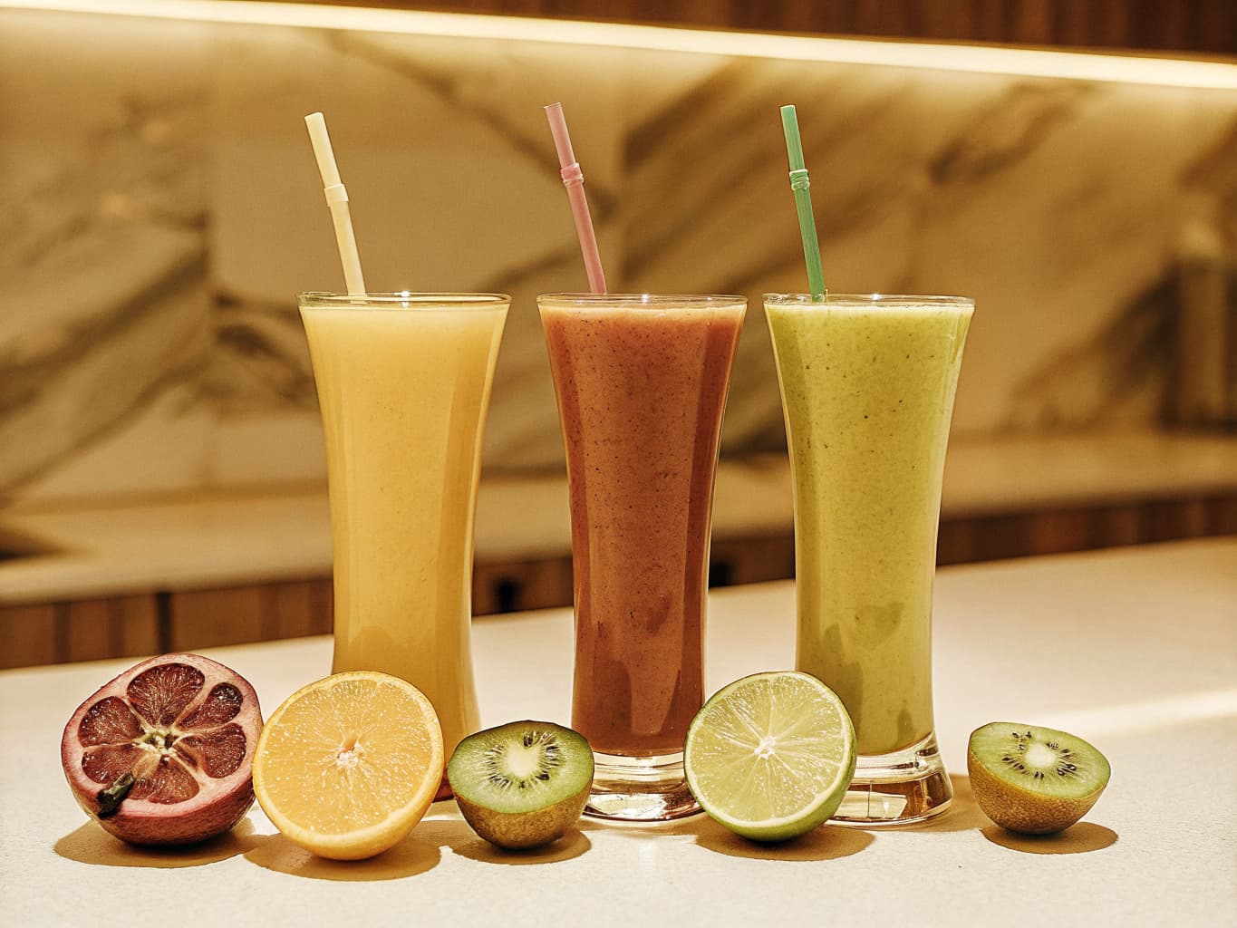 Fresh pressed fruit juices in colorful glasses