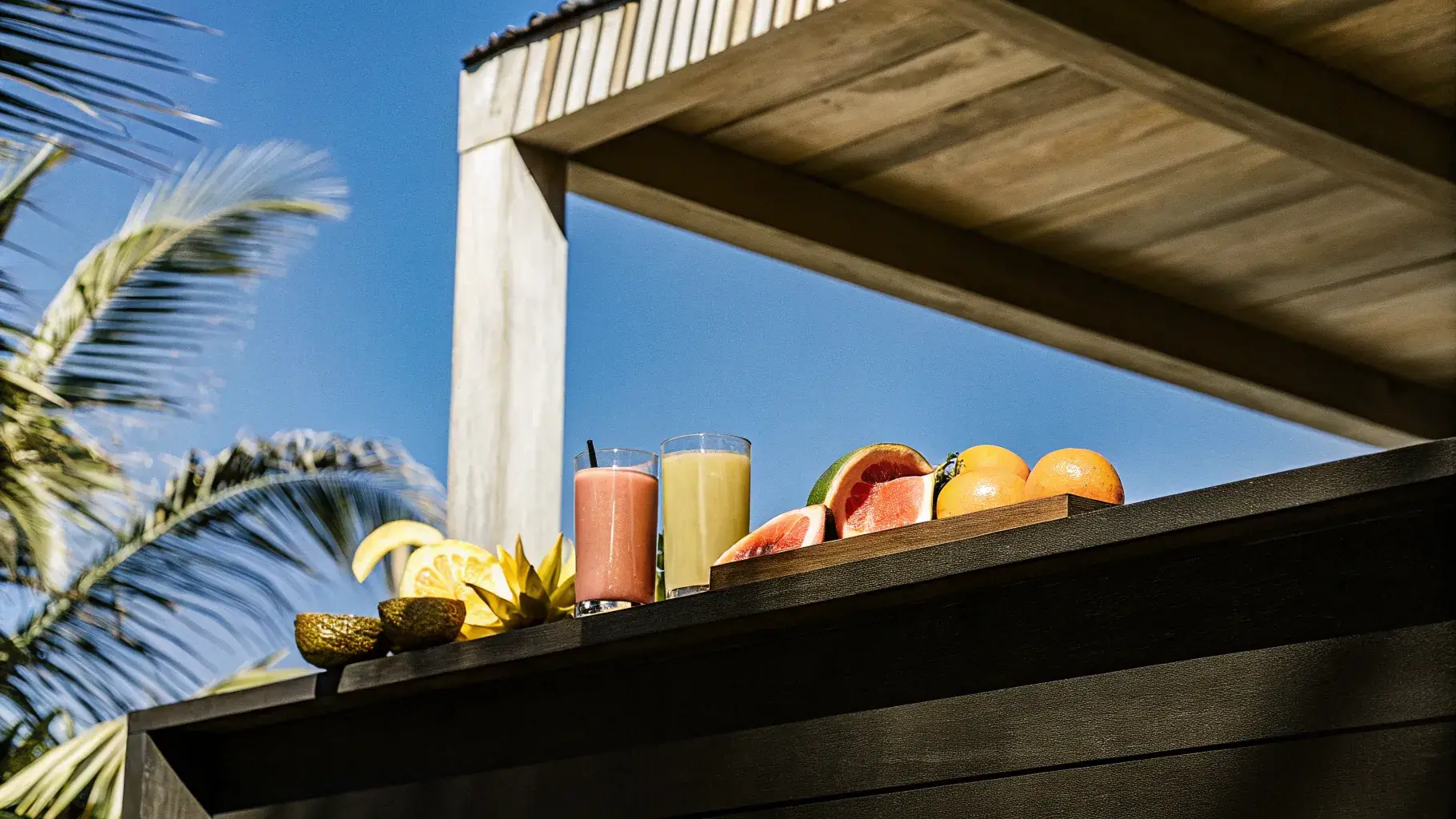 Colorful fresh tropical fruits and juice glasses
