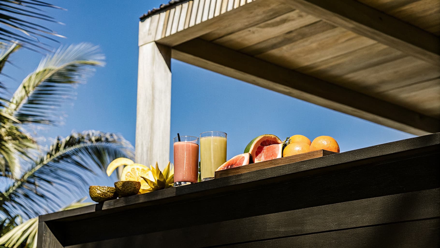 Colorful fresh tropical fruits and juice glasses